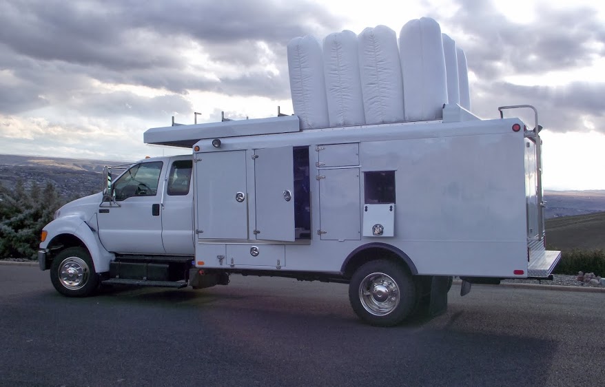 Duct Cleaning truck with bags coming out the roof.