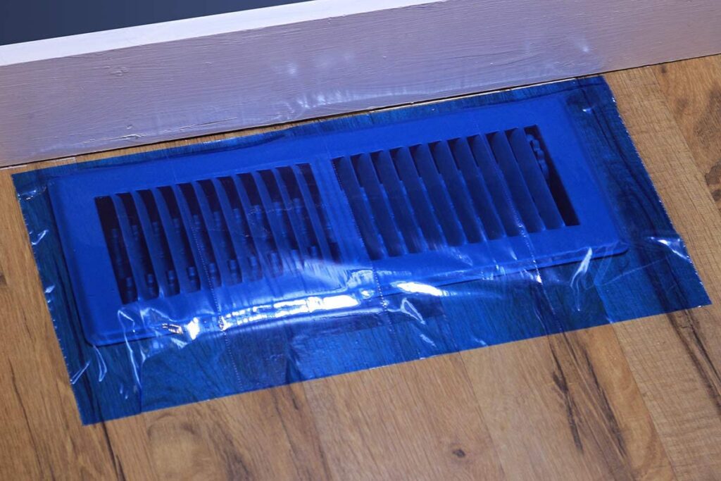 Blue duct mask over floor vent to prevent a mess.
