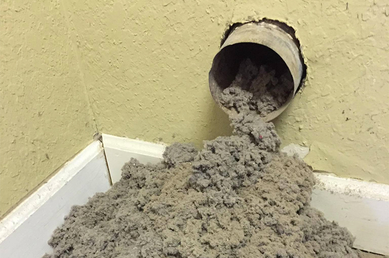 Lint plugged up in the wall vent.