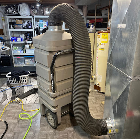 Our duct cleaning vacuum attached to a furnace in Milwaukee.