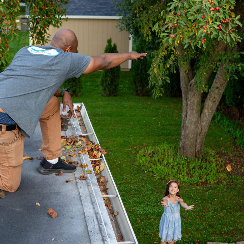 Throwing leaves out of a gutter in Milwaukee