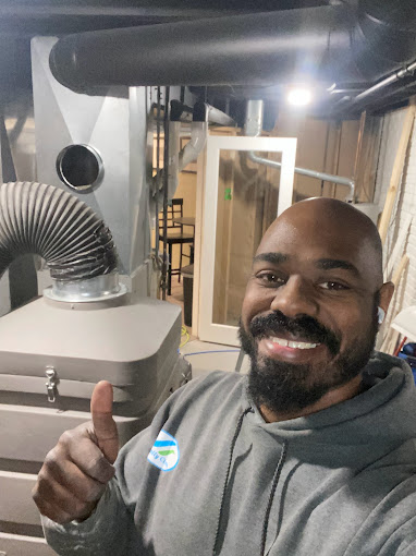 James Green, owner of Totally Clean standing next to his duct cleaning vacuum in Delafield, WI.