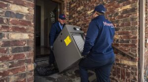 HVAC employees bringing in a new furnace to a home in wisconsin.