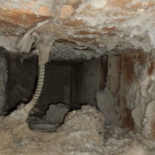 Filthy return ducting close up before the ducts are cleaned.